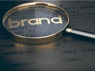 Magnifying glass over the word 'brand'